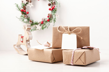 Mockup christmas and new year gifts with gift tags wrapped in craft paper