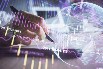 Financial charts displayed on woman's hand taking notes background. Concept of research. Double exposure
