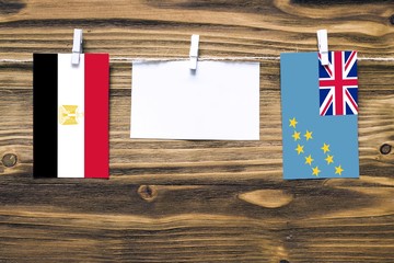 Hanging flags of Egypt and Tuvalu attached to rope with clothes pins with copy space on white note...