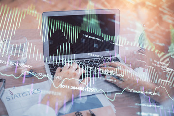 Multi exposure of forex graph with man working on computer on background. Concept of market analysis.