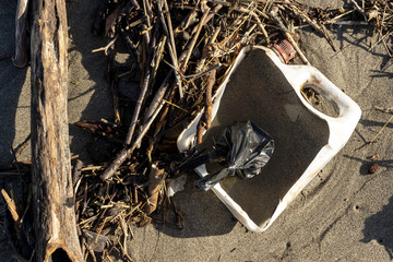Litter and Plastics washed up on the beach and remnant of floods in Spain