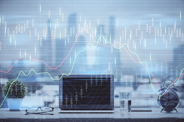Stock market chart hologram drawn on personal computer background. Double exposure. Concept of...