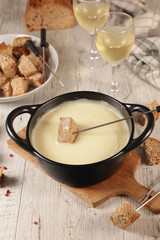 cheese fondue with baguette and white wine