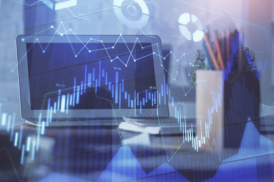 Stock market graph on background with desk and personal computer. Double exposure. Concept of financial analysis.