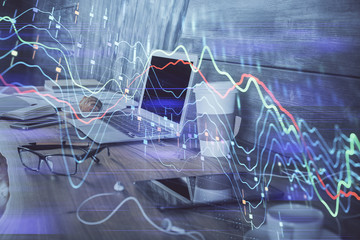 Forex market graph hologram and personal computer on background. Double exposure. Concept of investment.