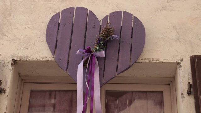 purple wooden heart, tilt shot of handmade decoration outside of a italian shop