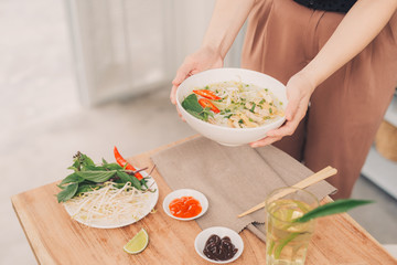 Asian dinner with vietnamese noodle soup pho bo,