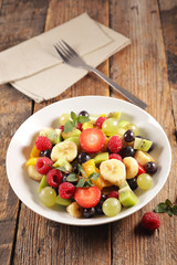 fresh fruit salad on wood background
