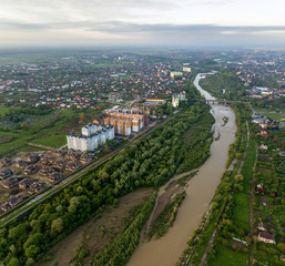 Aerial view of Ivano-Frankivsk city with residential area and suburb houses with a river in middle.