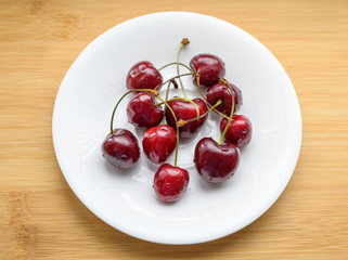 Cherry on the table in a cup. Selective focus.