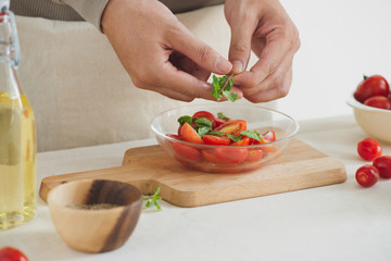 Fresh delicious salad with tomatoes. Doing fresh green salad