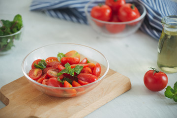 Fresh delicious salad with tomatoes. Doing fresh green salad
