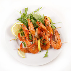 fried shrimp skewer with lemon and salad isolated on white background