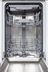 Empty new dishwasher with open door