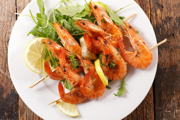 fried shrimp skewer on wood background