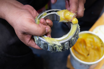Putting lithium grease into wheel bearing for ten wheel track by hand