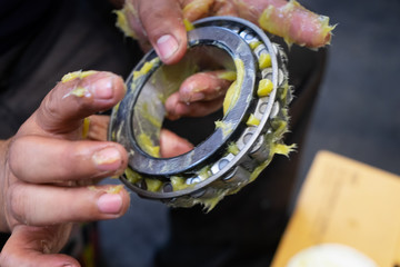 Putting lithium grease into wheel bearing for ten wheel track by hand