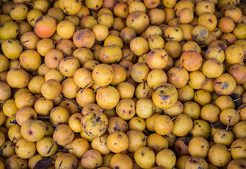 Natural-looking food in a street market - small pears.