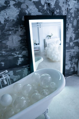 Modern bathroom with bathroom vanity, sink and large backlit illuminated mirror