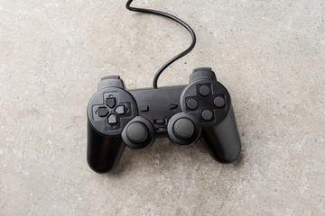 Black video game console on stone background. Top view. Close up