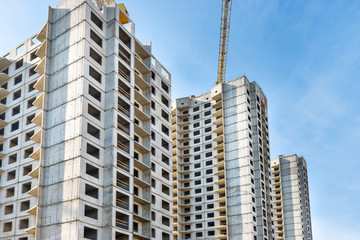 Construction site with buildings and industrial cranes