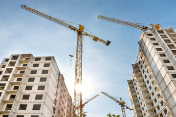 Construction site with buildings and industrial cranes