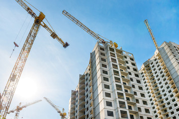 Construction site with buildings and industrial cranes