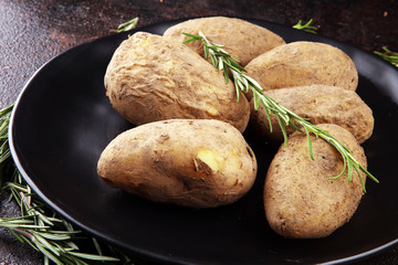 Pile of potatoes lying on a dish. Fresh boiled half potato and rosemary