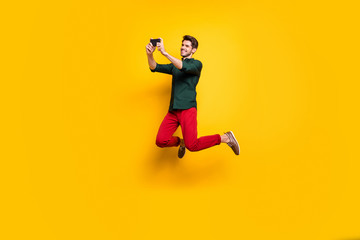 Turned full length body size photo of cheerful positive nice attractive man smiling toothily photographing empty space brown haired isolated vivid color background