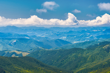 Blue mountains and hills landscape with blue sky and clouds