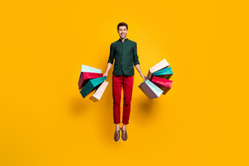 Full length photo of amazed funky crazy guy jump hear wonderful sales scream wow go shop buy...