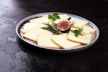 raclette cheese sliced. Very delicious swiss raclette on rustic background