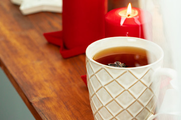 Close up shot of a cups of tea on wooden board at a Christmas interior