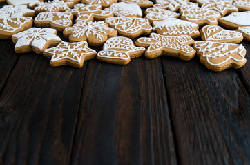 Christmas gingerbread of different kinds on a black and white wooden background