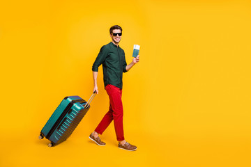 Full length body size photo side profile of man in eye wear wearing trousers smiling toothily cheerfully in green shirt isolated in footwear over vivid color background