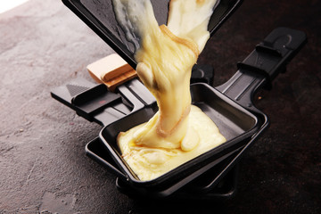 raclette cheese melted served in individual raclette skillets