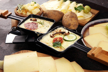 Delicious traditional Swiss melted raclette cheese on diced boiled or baked potato.