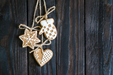 Christmas gingerbread of different kinds on a black and white wooden background