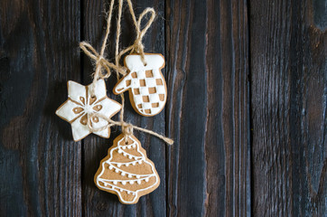 Christmas gingerbread of different kinds on a black and white wooden background