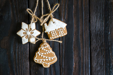 Christmas gingerbread of different kinds on a black and white wooden background