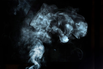 Abstract white smoke effect isolated on black background.