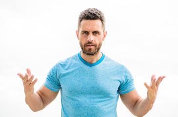 Naklejka premium sportswear fashion. muscular male with beard. man isolated on white. sportsman with athletic body. coach in fitness gym. after workout. man athlete in blue sport tshirt. what is going on