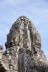 large faces carved on a tower of angkor thom temple