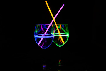 Colourful party mocktail in wine glass with dark background for holidays, christmas, new year and gathering leisure lifestyle