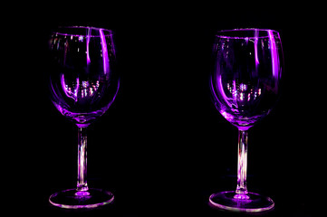 Colourful party in a restaurant wine glass light reflection with dark background for holidays, christmas, new year and gathering leisure