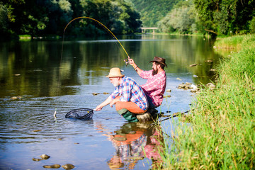 Fototapeta na wymiar Spinnerbait. fly fish hobby of men in checkered shirt. retirement fishery. happy fishermen friendship. Two male friends fishing together. Catching and fishing. retired dad and mature bearded son