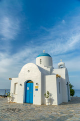 Fototapeta na wymiar The picturesque Orthodox temple, built in the Greek style, is located on the coast of Cyprus.