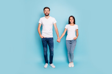 Fototapeta premium Full length photo of candid spouses married sweethearts have weekend holiday date wear good look outfit sneakers isolated over blue color background