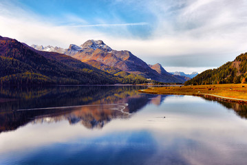 Mountain lake panorama with mountains reflection. Idyllic look. Autumn forest. Silvaplana Lake, Switzerland