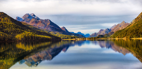 Mountain lake panorama with mountains reflection. Idyllic look. Autumn forest. Silvaplana Lake, Switzerland